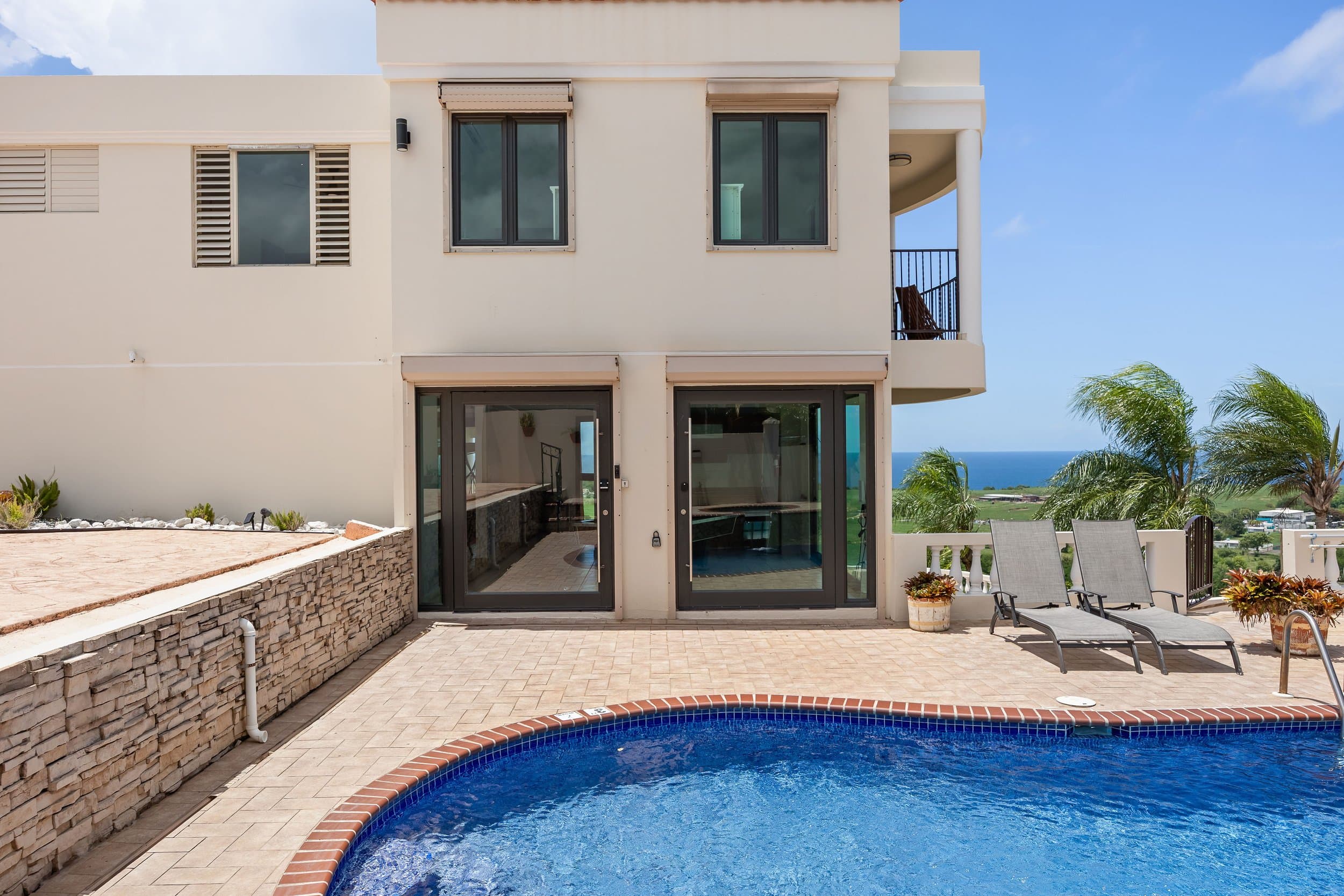 The villa over its pool